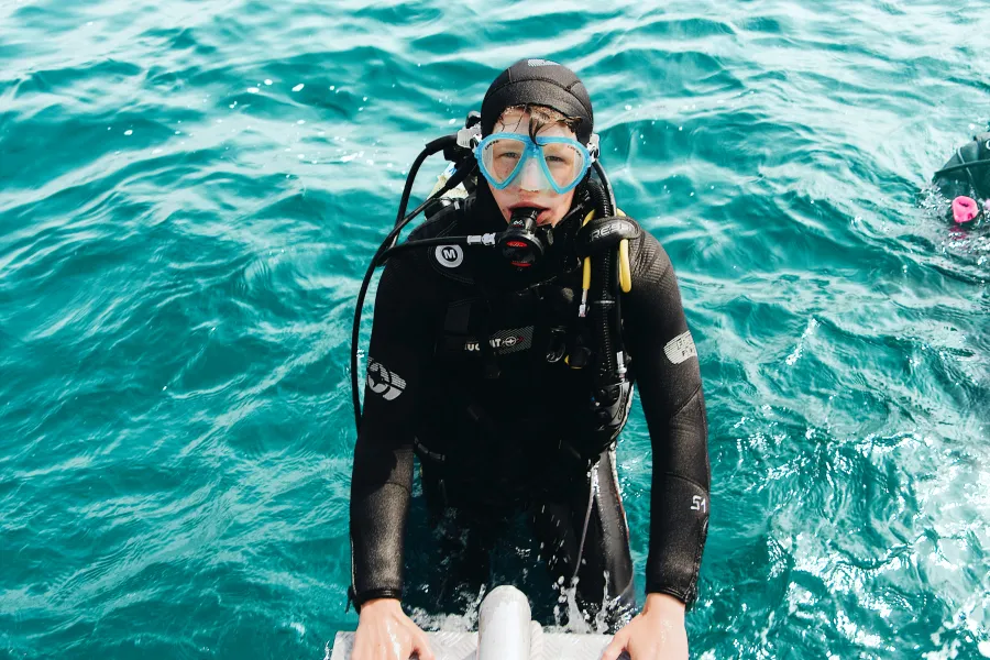 Diver underwater with fish